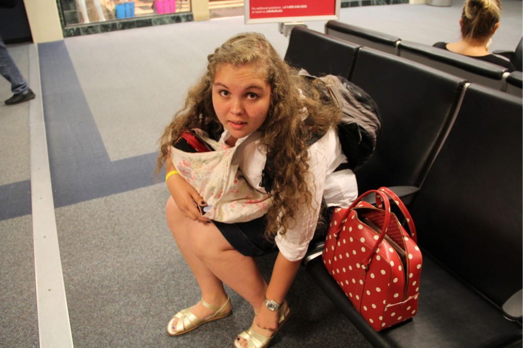 g adjusting her gold sparkly sandals before the long flight